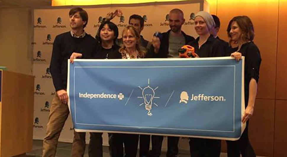 The Tigerdrone team holding and Independence Blue Cross / Jefferson banner