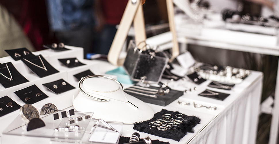 NextFab member displaying jewelry made at the makerspace