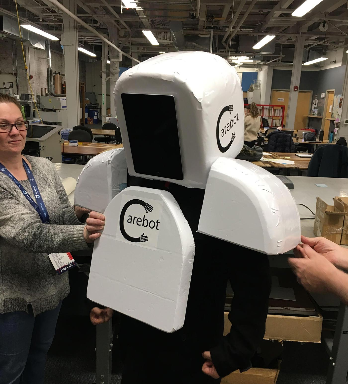 NextFab "Reimagining Death" team try on their "Carebot" prototype.